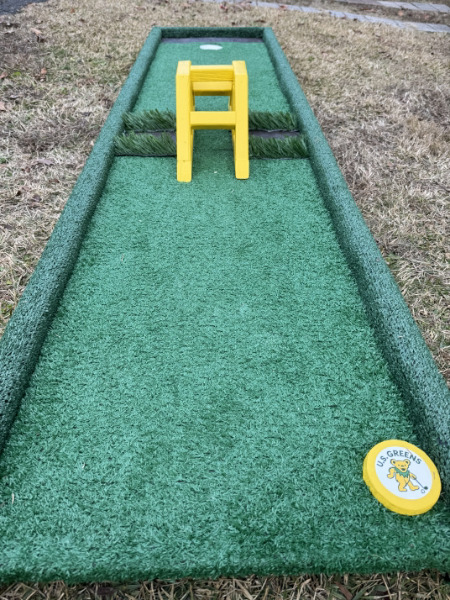 Portable putting green with goal obstacle